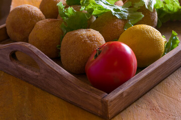 Arancini, Sicilian street food. Rice's balls with meat and vegetables.