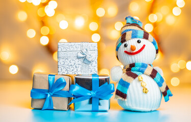 Snowman and Christmas gifts on bright yellow background