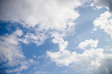 Light blue sky with natural white fluffy clouds