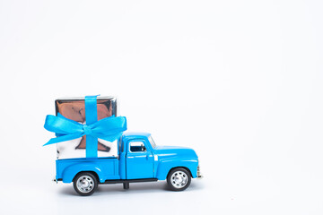 Blue retro toy car delivering gift box