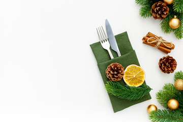Christmas table setting with fir tree and gold toys on white background flat lay