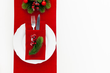 Table setting with spruce, plate, flatware on white background top view
