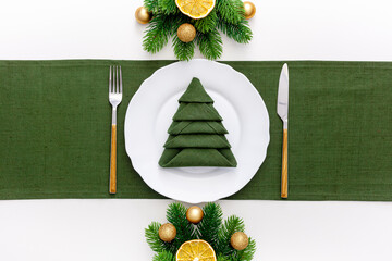 Christmas table setting with fir tree and gold toys on white background flat lay