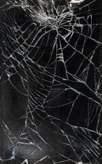 top shot of broken smartphone front glass surface, shattered mobile device texture macro.