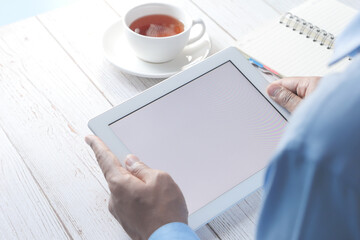  rear view of businessman using digital tablet on office desk 