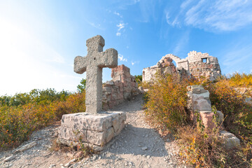 Fototapeta na wymiar large stone historic cross in the mountains