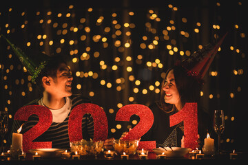 Young Asian couples are celebrating the New Year with night lights and 2021 numbers.