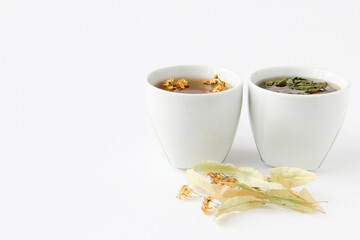 Two white cups of herbal tea. Additional, alternative treatment.