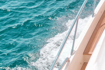 Fototapeta na wymiar Water track view from deck of luxury yacht, sea waves, foam, deck floor, white board
