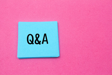 note paper written Q&A over pink background