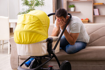 Young male contractor looking after new born at home