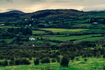 Hills of green rural fields in the countryside of Ireland.