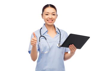 medicine, profession and healthcare concept - happy smiling asian female doctor or nurse with tablet pc computer and stethoscope showing thumbs up over white background