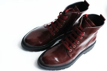 wine-colored patent leather shoes with red laces, on a white background, isolate. Fashionable, stylish shoes, own tannery, ruin of a small business.
