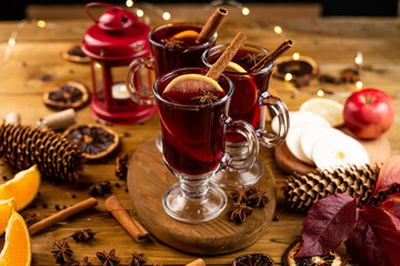 Christmas magic atmosphere, home celebration. Hot mulled wine, spices and festive decorations. Winter holidays celebration concept