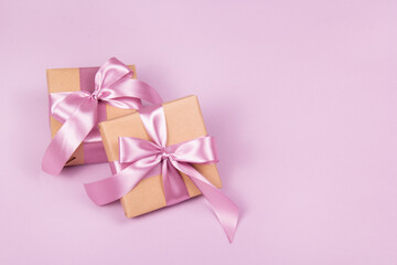 Simple gift boxes with bow on pink background