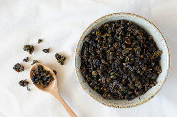 gaba tea from Taiwan in wooden spoon and cup on linen background