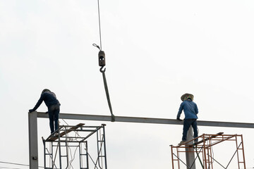 Construction Scaffolding Worker conect the steel beam by gas welding equipment