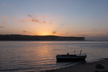 Fishing boats on a river sea at sunset in Foz do Arelho, Portugal