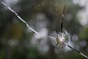 Selected focus on Broken cracks glass fracture effect texture on old window isolated abstract background. Broken glass for background pattern. Hole in old window.