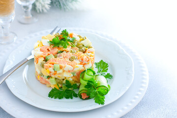 New Years festive salad with red fish on a white plate, horizontal, place for text