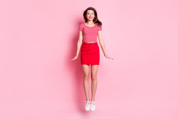 Full size photo of young beautiful smiling cheerful charming girl with red lipstick jump fly isolated on pink color background
