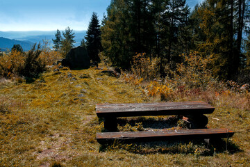 rustic picnic table and benches on the top of the Wdżar Mountain in Kluszkowce, Pieniny, Poland