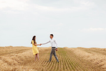 Happy young couple on straw, romantic people concept, beautiful landscape, summer season.