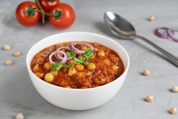 Chole masala or chana an indian street food made of chickpeas, tomatoes and cumin decorated with...