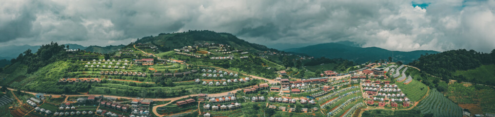 Fototapeta premium Aerial view of camping grounds and tents on Doi Mon Cham mountain in Mae Rim, Chiang Mai province, Thailand