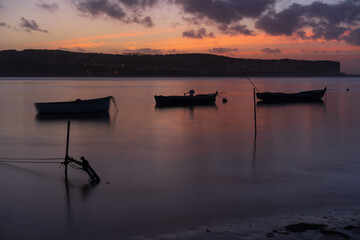 Fishing boats on a river sea at sunset in Foz do Arelho, Portugal