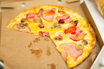 Pieces of pizza in a cardboard box.