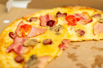 Pieces of pizza in a cardboard box.