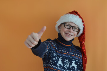 happy positive confident child looks at the camera and smiles thumbs up, concept win, success, sale