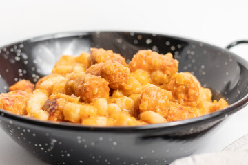 White bean with chorizo ​​in a typical black casserole, typical Asturian food