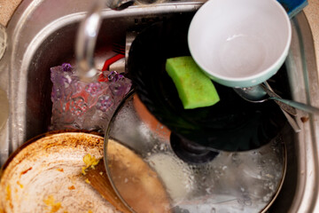 Dirty dishes in the kitchen sink.