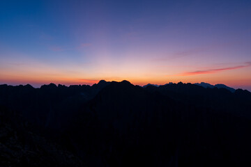 Panorama of early sunrise in the mountains. Summer clear sky with rising sun in the high Tatras in Slovakia. Nice scenery on top in Liptov region.