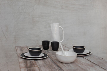 Ceramic kitchenware, ceramic water jug, a ceramic mug, and a ceramic plate.