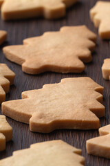 Top view of decorated Christmas tree cookie on wooden table background with copy space.