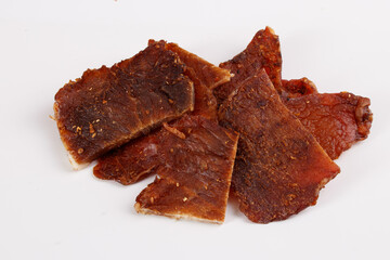 pieces of dried chicken with spices, snacks for beer isolated on white background