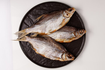 dried silver bream fish, snacks for beer on plate isolated on white