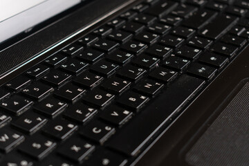 Black laptop and notepad on wood surface. Work space. 
