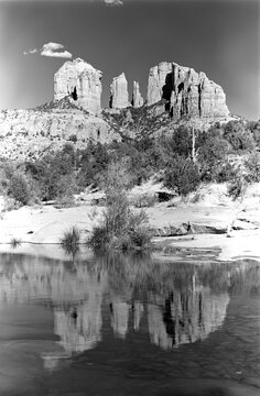 Cathedral Rock with Small Cloud and Water Reflections in Oak Creek at Red Rock Crossing in Sedona Arizona USA