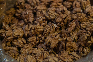 Walnuts background with selective focus. Large kernels walnuts without shell. Top view. Concept of vegetarian or healthy eating. Organic close-up.