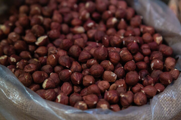 Hazelnuts heap without shell, flax nut texture. Concept of vegetarian and healthy eating. Hazelnuts fried without shell. Organic background. Top view close up.