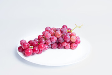 Red grapes on a white background.