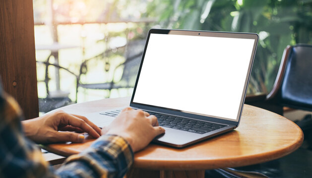 computer blank screen mockup.hand woman work using laptop with white background for advertising,contact business search information on desk at coffee shop.marketing and creative design