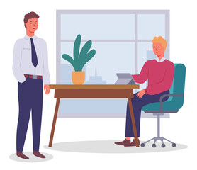 Office workers. Colleagues communicating. Executive guy wearing office suit talking with man sitting at table using digital tablet. Business people discuss a new project or startup working together