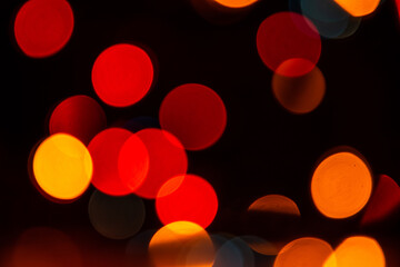 Very soft focus on christmas lights.Colorful new year lights on black background.Blurred christmas lights with copy space.Bright colorful dots.New year decoration.Holiday backgrounds for designers