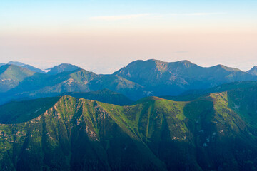 Fototapeta premium Scenic image of Fairytale mountains during sunrise. The sunrise over a mountain in park High Tatras. Slovakia, Europe. Wonderful Autumn landscape. Picturesque view of nature Amazing natural Background